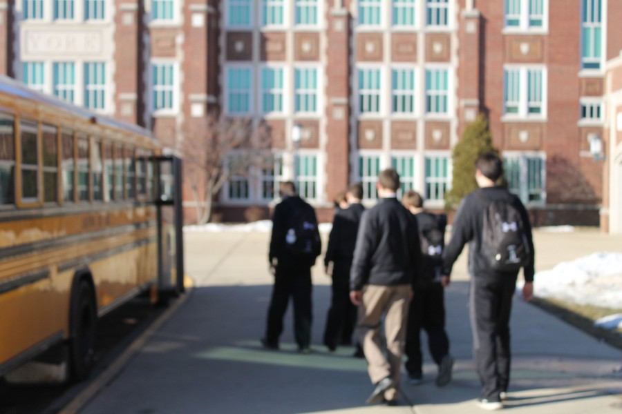 The York Varsity Boys Basketball team boarding the bus before suffering a rough loss to Naperville North (66-48).
