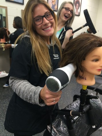 Senior Alexis Bojesen practicing hair at cosmetology school