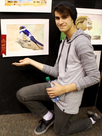 Nathaniel Swanson presenting his 2nd place oil painting. "I'm very surprised I got 2nd place for my painting, this inspires me to create more paintings in the future," said sophomore Nathaniel Swanson.