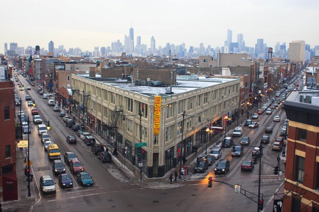 The Chicago skyline hovers over the busy intersection of Milwaukee Ave. and Division St. in Wicker Park.