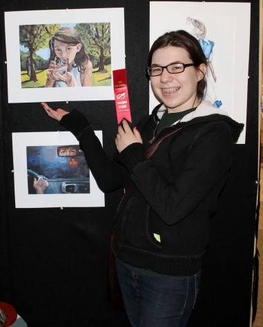 Alexandria Roeschlein is awarded a 2nd place ribbon for her portrait of her emotion of paranoia. "I decided to paint a picture of when I was most paranoid in my life which is in a calm setting," senior Alexandria Roeschlein.
