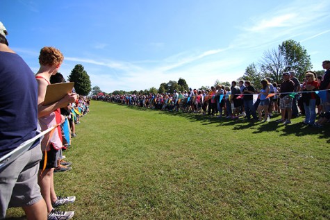 Spectators line the end of chute eagerly awaiting the arrival of the first runners in the varsity race.