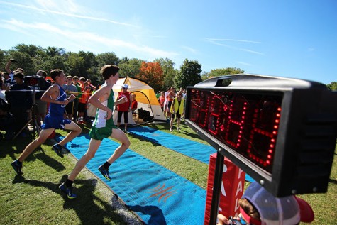 Tommy Devereux, senior, runs hard into the finish with a time of 15:41.