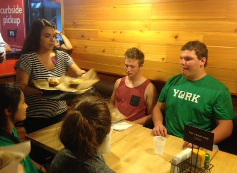 Senior Nick Brown (left) and junior Chuck Walsh (right), representing the York Football Team, eagerly awaited their burger before the competition began.