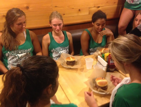 Senior cheer members Jasmine Santos, Madison Hoffman, and Marina Johnson (left to right), nervously waited until they were told to start eating.