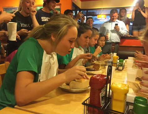 Representing the York Girls’ Cross Country team, Seniors Jessica DiChiara and Sara Acosta and Sophomores Rachel Lezak and Emma Tran (left to right) dove into their six-layer burger one patty at a time. 