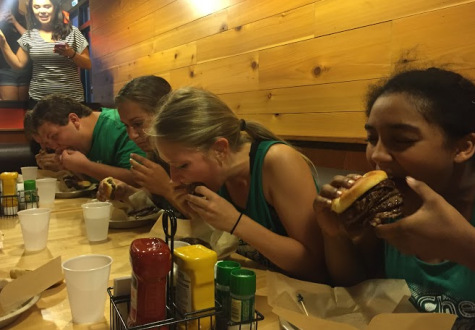 Cheerleaders Jasmine Santos, Madison Hoffman, and Marina Johnson attempted to eat all six hamburger patties at once.