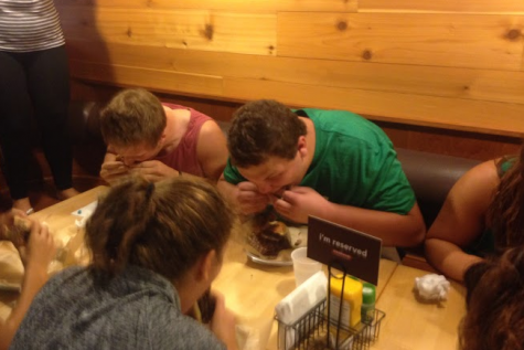 Football players Brown (left) and Walsh (right) dipped their burgers in water before they attempted to eat each patty individually.