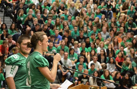 Matt Wozny and Tom Helton rally fans for the football game.