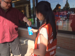 Key Club member Honey Tey getting a donation at Jewel Osco during the Kiwanis Peanut Day event.
