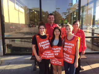 Key Club members Honey Tey, Esther Povh and Gracie Tully with the Jewel Osco managers after raising money at Kiwanis Peanut Day