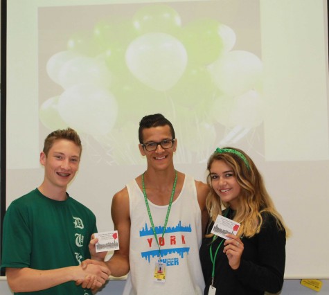 Quinn Corcoran, sports editor of York-hi, presents Matt DeJesus and Alyssa Taylor with two free tickets to Homecoming.
