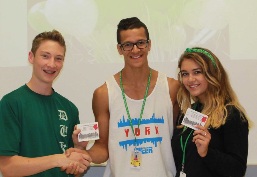 Quinn Corcoran, sports editor of York-hi, presents 2015 Homecoming Proposal Contest winners, Matt DeJesus and Alyssa Taylor, with two free tickets to Homecoming. Sept. 2015.