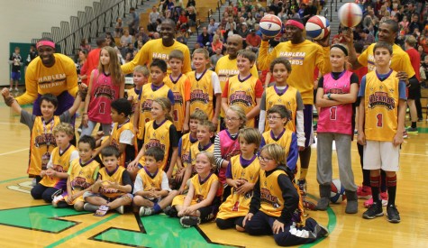 Harlem Wizards celebrate with fans who wore their jerseys.