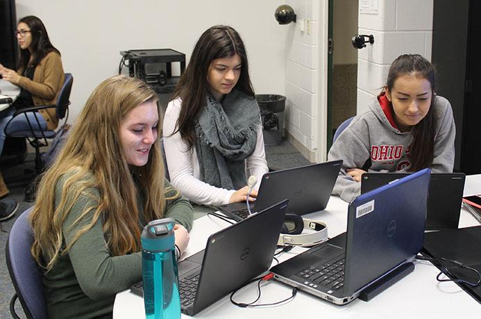 Juniors, Juliana Gescey, Amy Rogala, and Yizcel Carrera, work in Yorks mediascape lab for their Spanish 4 Honors class.