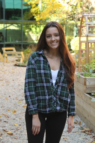 Gracie is sporting a flannel top with black leggings.