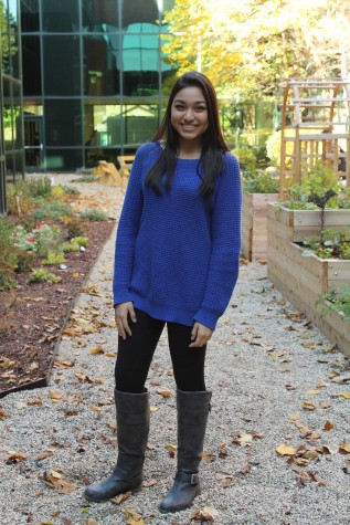 Monica is seen wearing knee high boots with an oversized sweater.