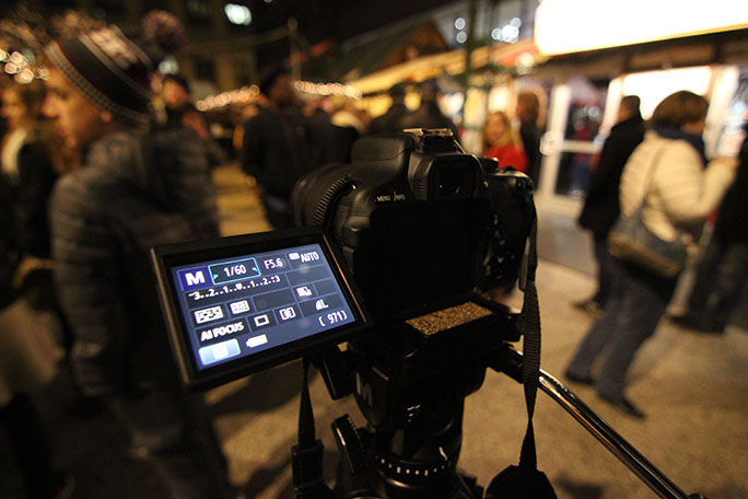 The camera is set up and ready to film among the bustling crowds of a Friday night in Chicago.