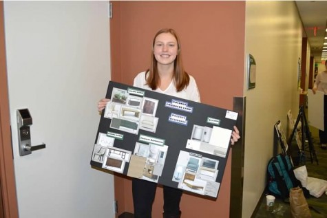 Sophomore Allison Evans proudly holds up her display for her interior design category in Friday’s competition.