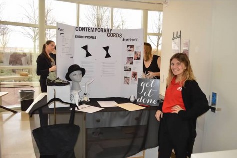 Junior Madison Miller stands next to her garment and display after her presentation to the judges had ended.
