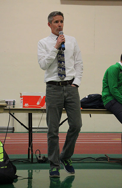 Head Coach Charlie Kern announces the events of the dual meet against Downers Grove South High School.
