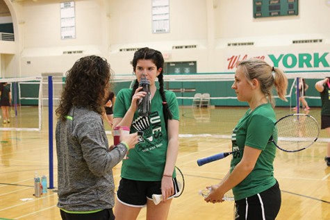 Head coach Nicole Young talks to 2nd doubles players, Rosie O'Connor and Catherine Novak.