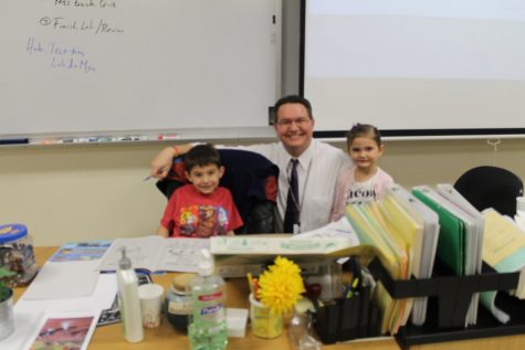 Science teacher Mr. Golebiowski has his kids coloring at his desk while he teaches.