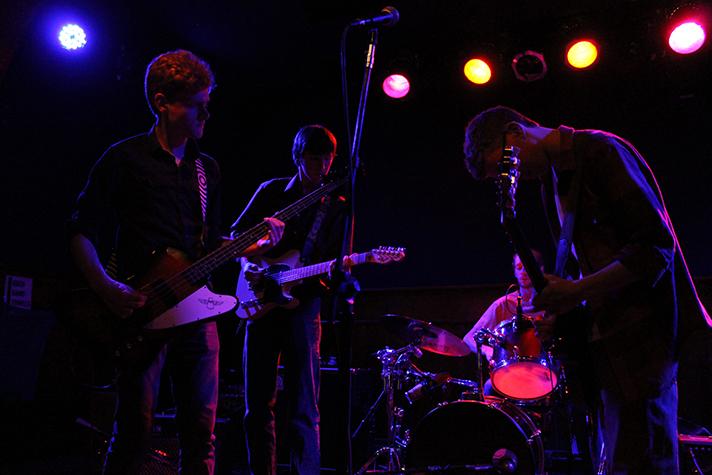 Junior Alexander Stezowski (middle) accompanied by  Grant Mitchell, senior, on bass (left) and  Bennet Berman, junior, (right) on guitar. Also with Liam Fisher, senior, on drums (back). 