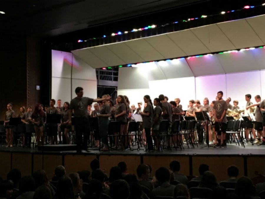 Brian Berg, Director of Middle School Bands, congratulates the summer concert band students after their performance.