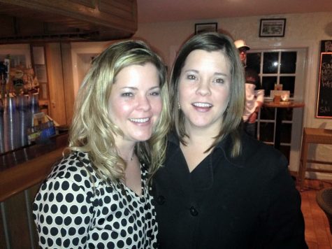 Mrs. Deluga catches up with her twin, Maureen Kelly, at a family party.