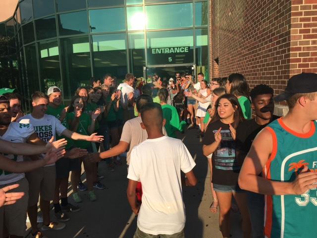 Students from the Class of 2020 process through a canyon of cheering upperclassmen as the enter the athletic wing for Freshman Night on Tues., Aug. 9
