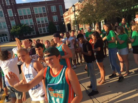Upperclassmen greet the Class of 2020 as they arrive at the doors to the athletic entrance on Tues., Aug. 9.