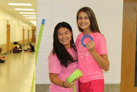 Kiya Lawler and Caroline Noonan, freshmen, help YSET decorate the hallway.