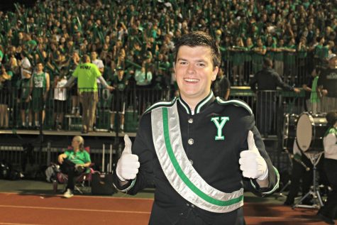 Drum major Emmett O'brien give his last homecoming game two thumbs up.