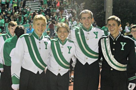 Marching band members Frank Luse, Brian Strauch, Gaby Uribe, and Jack Gornick gather together for their last homecoming game at York.