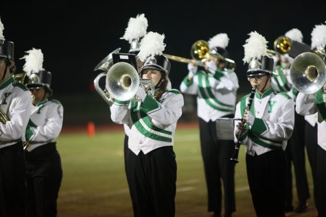 Abril Stoddard, sophomore, and Sam Jensen, freshman, play their instruments during the homecoming football game for the Poms feature.