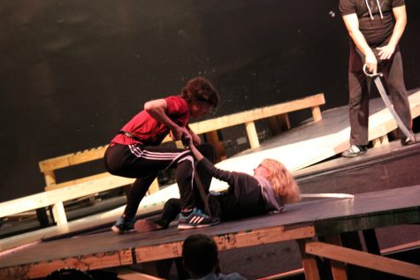 Mercutio guards herself against blows from Tybalt. 