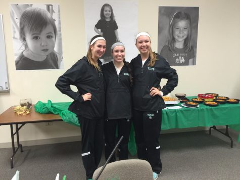 Senior Captains Sydney Bonthron, Sarah Rose, and Kristie Paus pose in front of their respective childhood pictures at their Senior Night reception.