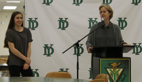 Senior Sarah Rose listens with a smile as Ms. Patty Iverson speaks of the many accomplishments, on and off the volleyball court, that earned her Student of the Month for Athletics.