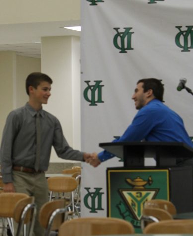 Sophomore Jack Raniere is awarded Student of the Month for World Language from Mr. Joe O'Malley.