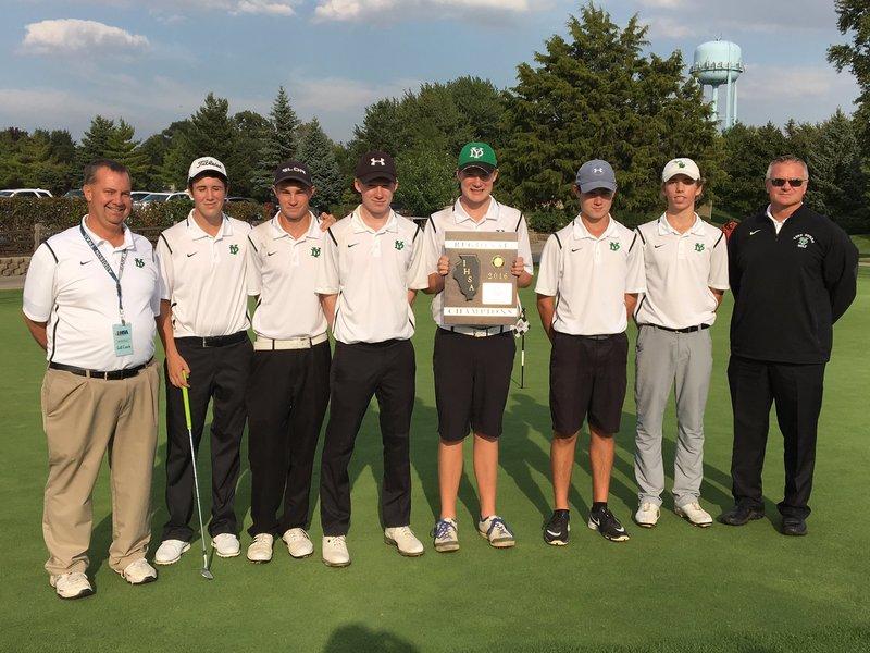 The varsity boys golf team show off their second place trophy after their win. 