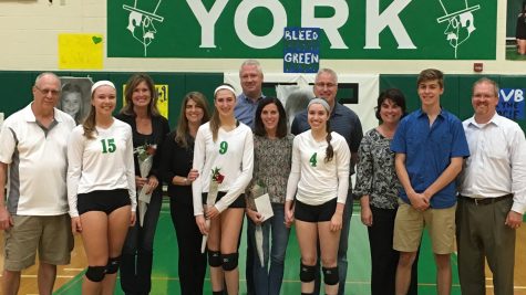 Senior varsity players Kristie Paus, Sydney Bonthron, Sarah Rose, and team manager Evan Haug, celebrate with their parents after the game.