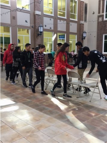 Members from both clubs invite other students to play in an intense game of musical chairs during lunch.