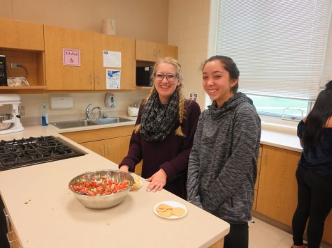 Emma Phillips, junior, and Micki Neidigh, freshman, smile ear to ear before creating their own nachos.