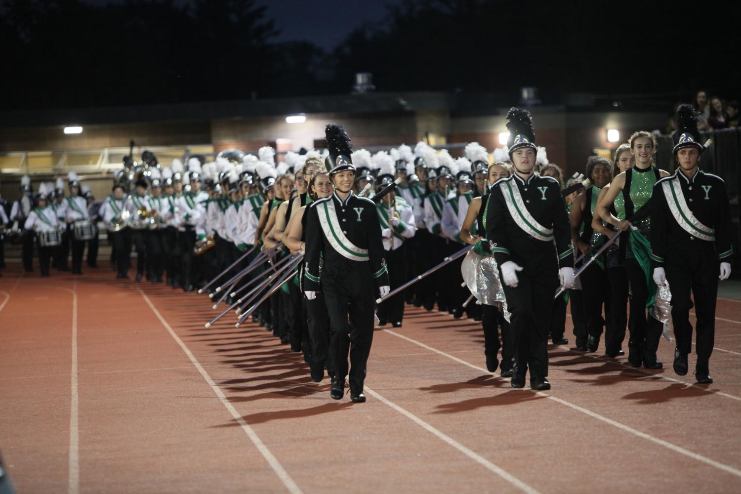 We march over with the band at the football games, following the drum majors.