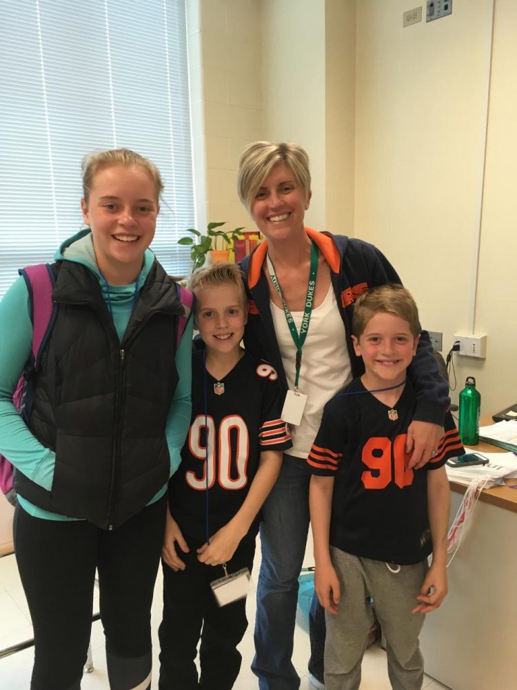 English teacher, Mrs. Fleming brought her kids Maggie (12), Tim (10), and Casey (7), to school. The kids saw her many different classes and Tim worked on his English homework during her sixth period class. 