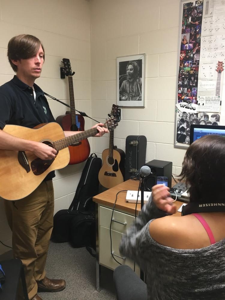 Mr. Gemkow helps Tanya Guerrero, junior, with a guitar part for her final project
