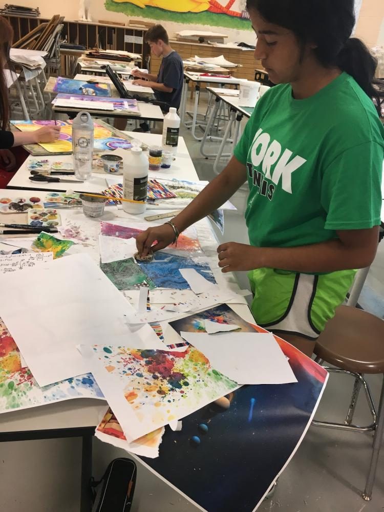 Sonali Kumar works on a collage painting.
