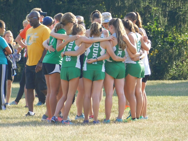 The Frosh/Soph team huddles together before the start of their race at the Peoria Notre Dame Richard Spring Invite 