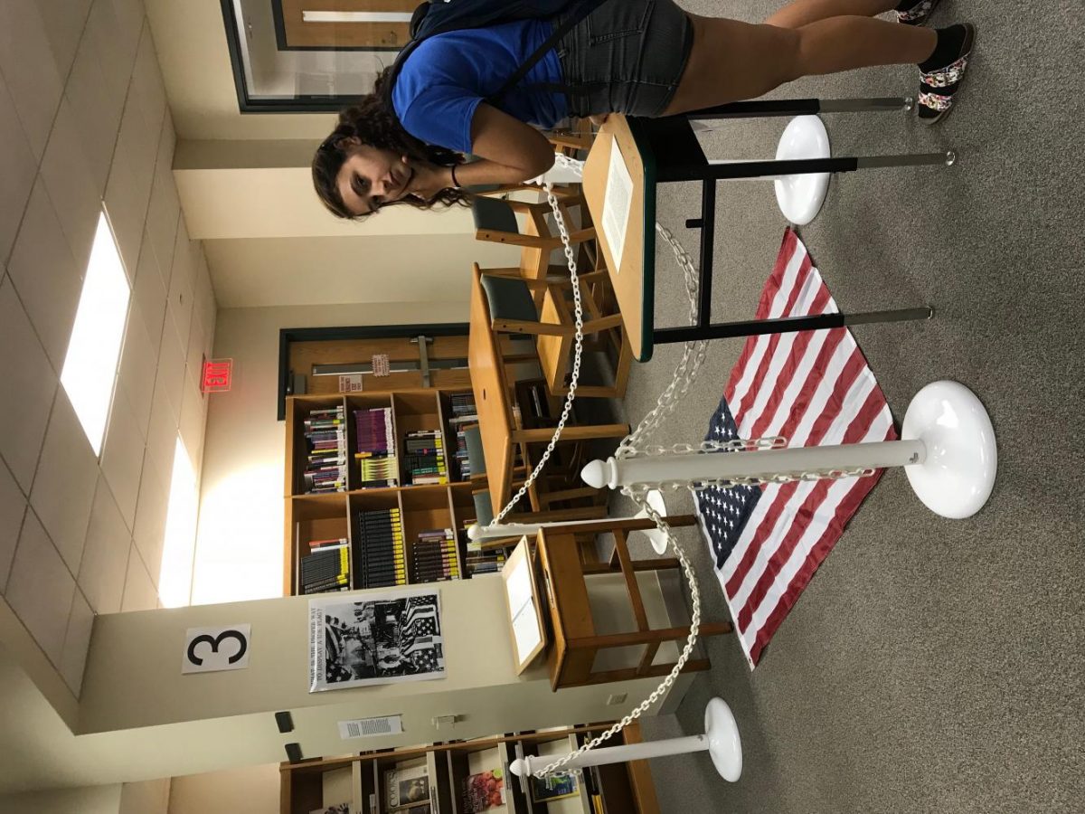 Sophomore Emily Belcher looks at Dread Scotts What is the Proper way to display a U.S. Flag? in the York Learning Commons Tuesday morning. Sept. 26, 2017.